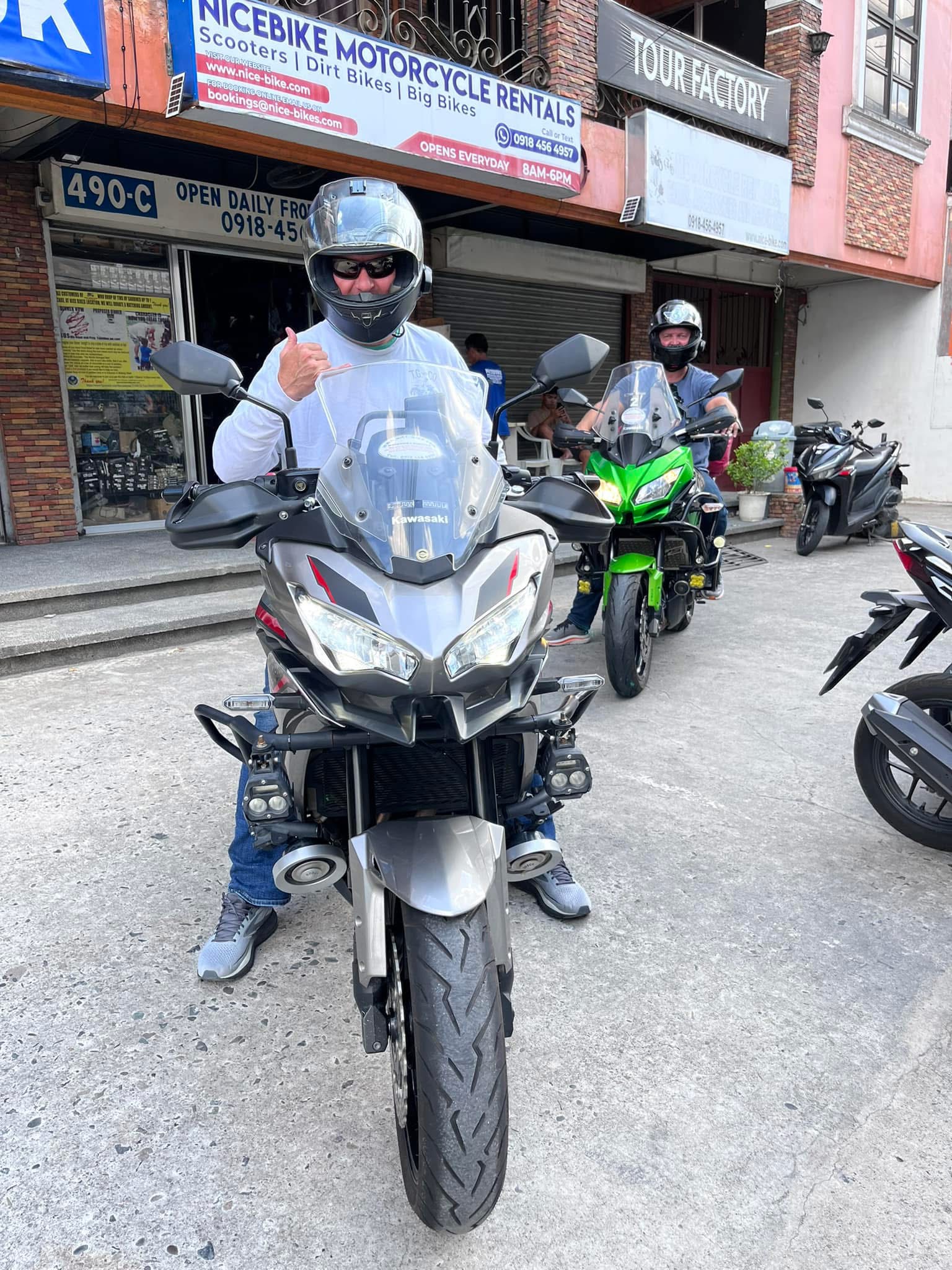 Customer sitting on a Kawasaki motorcycle outside NiceBike